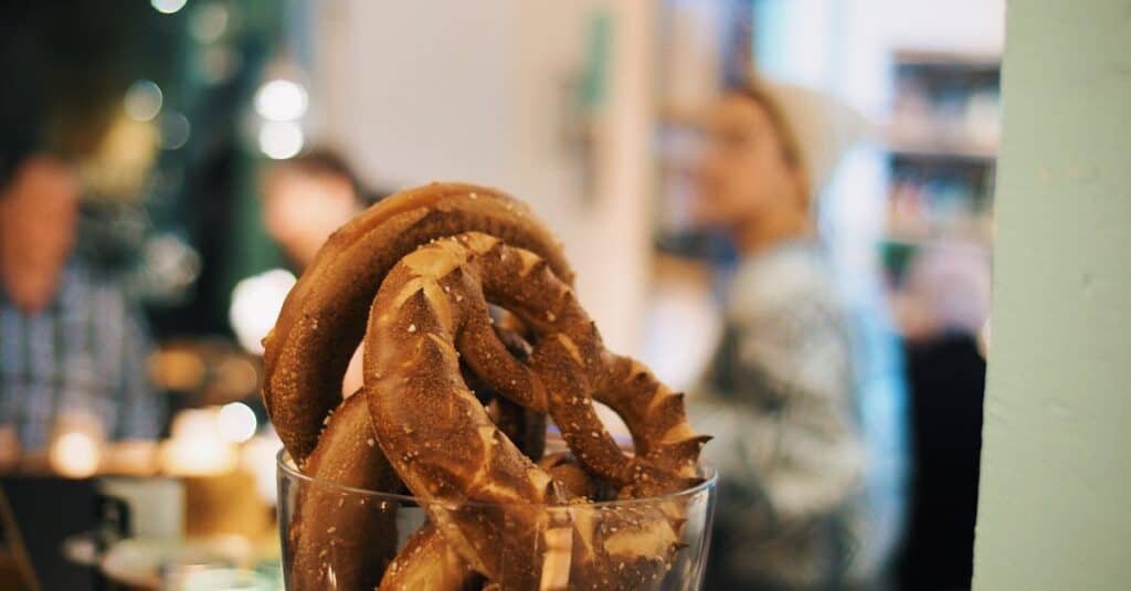 pexels-photo-1718383-1718383-1 Appetizing pretzels in a glass jar, captured in a cozy café atmosphere.